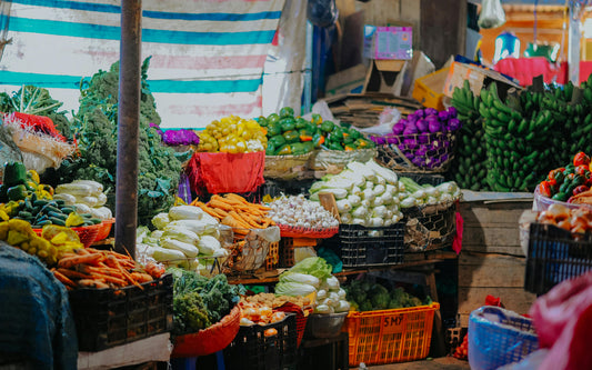 Assorted fresh vegetables on wooden crates at market