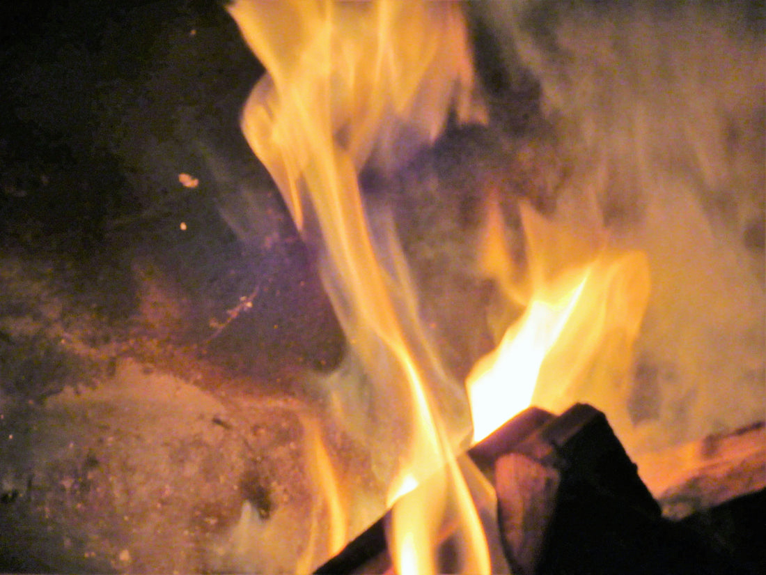 Outdoor South African braai with fire and meat on the grill